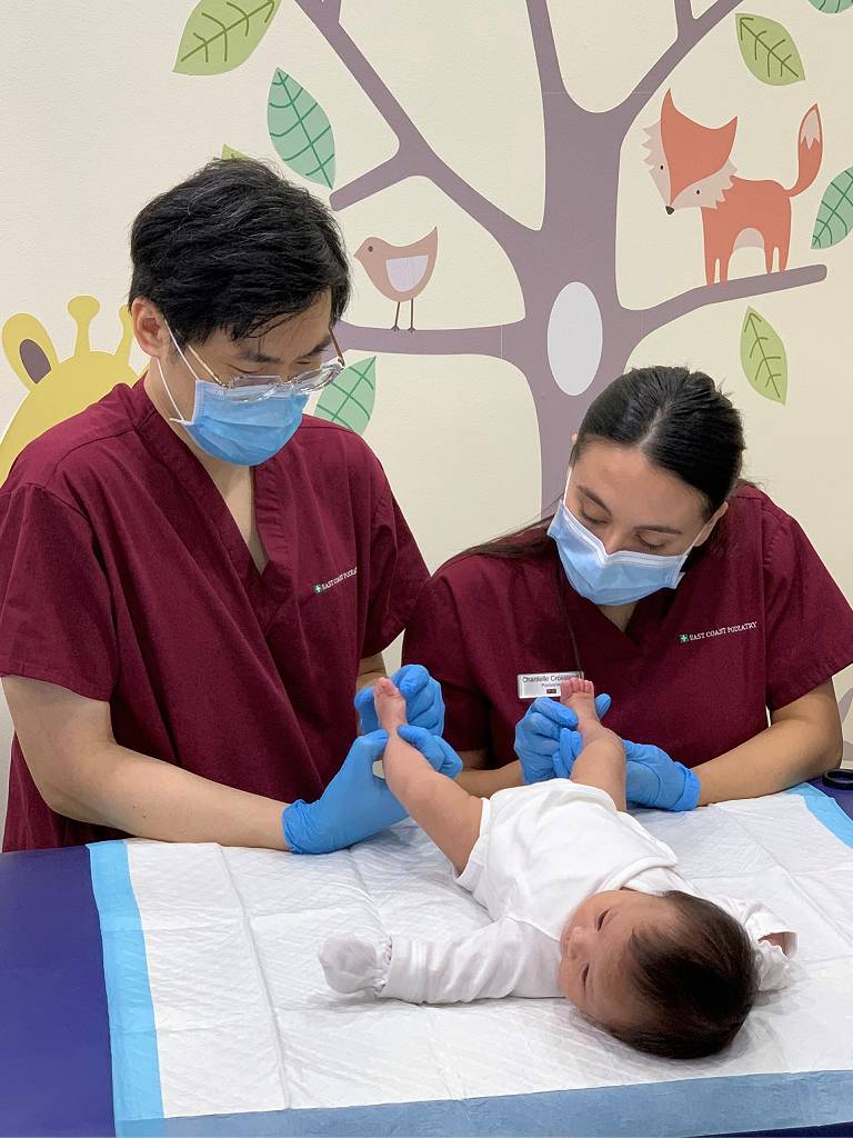 Podiatrists Dr. Michael Lai & Chantelle Crossland treating bow legged infant